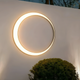 Emerging Outdoor Lighting Trends Shaping 2026 Spaces with a modern circular wall light design.