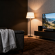 Modern floor lamps for living room illuminating a cozy seating area with a TV and stylish decor.