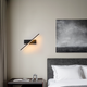 Modern bedroom lighting guide featuring a stylish wall lamp and cozy bed setup.