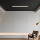 Modern living room showcasing lighting layering techniques with a floor lamp and wall sconces.